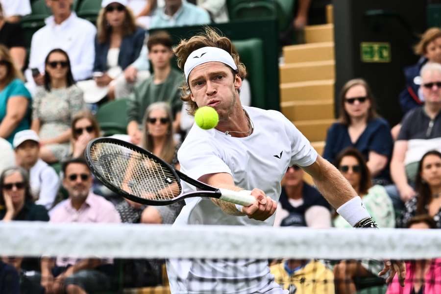 Andrey Rublev returns the ball to Max Purcell during their match on the first day of the 2023 Wimbledon Championships