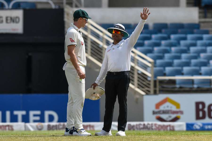 Australia captain Pat Cummins in discussion with Nitin Menon during Australia's most recent Test.