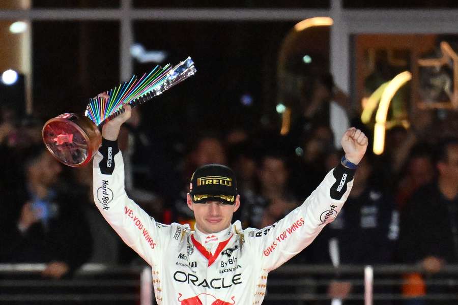 Max Verstappen celebrates with the trophy on the podium after winning the Las Vegas Grand Prix in 2023