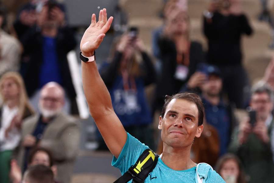 Rafael Nadal gestures to the public as he leaves the court after losing against Alexander Zverev