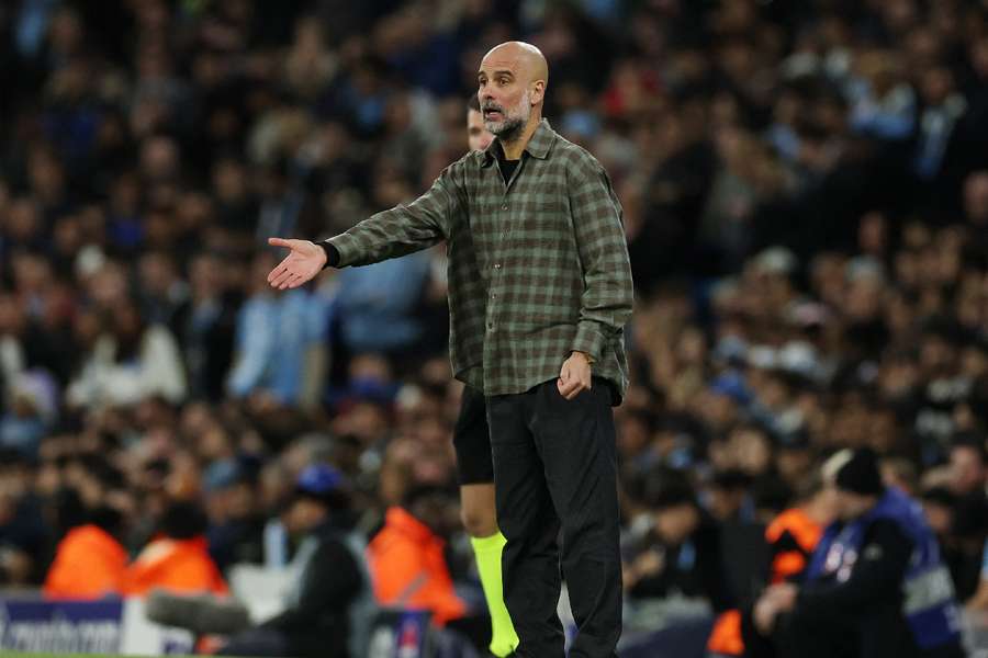 Pep Guardiola looks on 