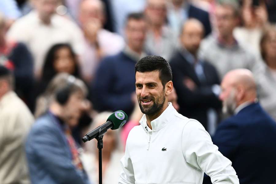 Novak Djokovic speaks to the crowd after the match