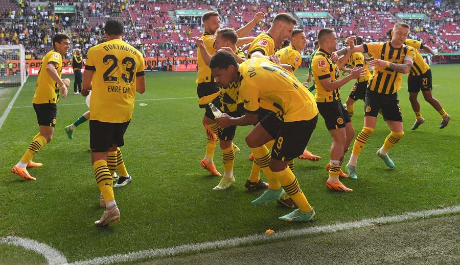 Dortmund's players celebrate after winning the German first division Bundesliga football match between FC Augsburg and BVB Borussia Dortmund