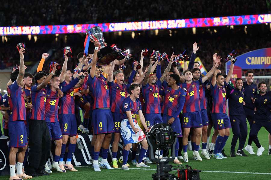 Barcelona players lift the trophy after winning LaLiga