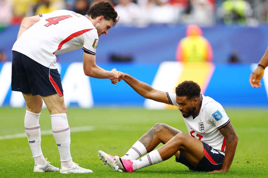 James (right) is helped up by Rice