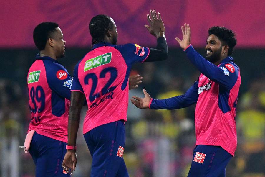 Rajasthan Royals' Wanindu Hasaranga (right) celebrates with teammates after taking the wicket of Chennai Super Kings' Rahul Tripathi