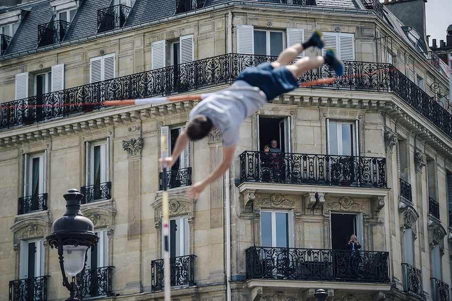 People watch a French athlete performing from their balconies, 2018