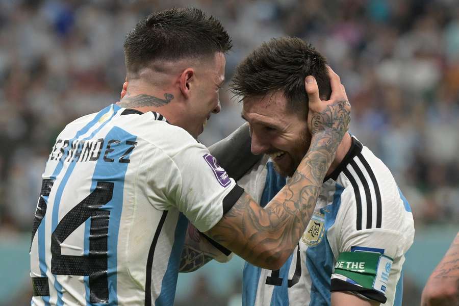 Argentina's Enzo Fernandez celebrates with Lionel Messi
