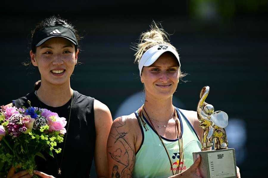 Vondrousova (right) with her trophy alongside Wang (left)