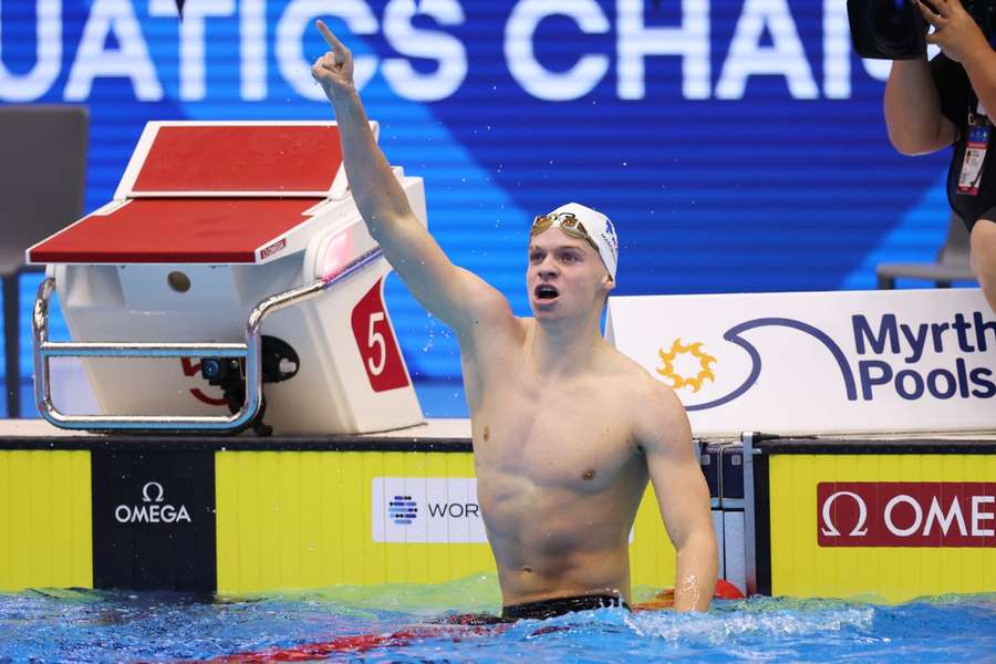 Leon Marchand celebrates after winning the men's 400 metres individual medley