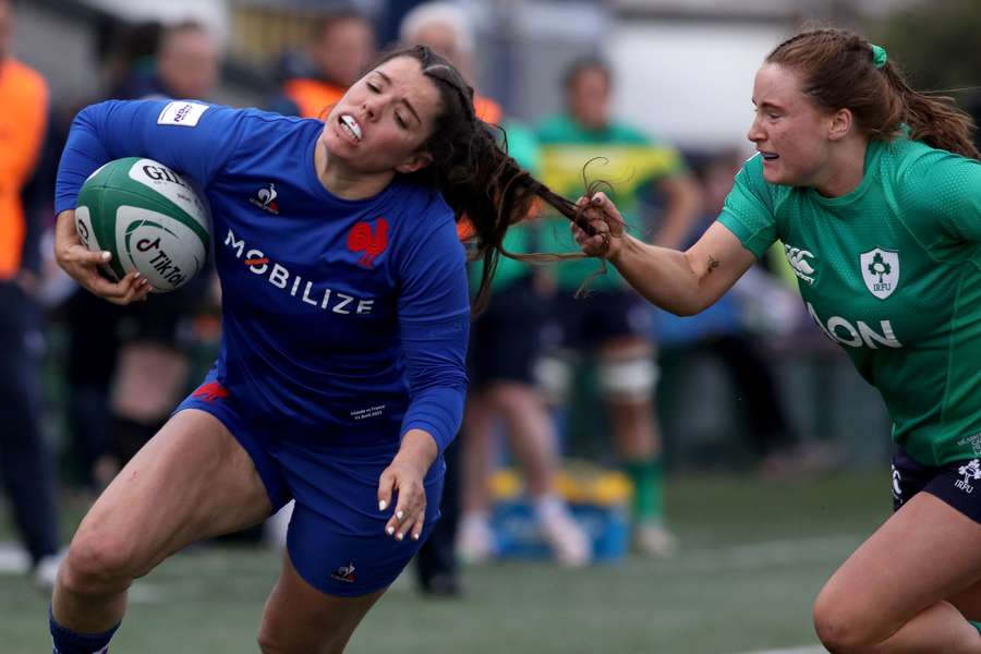 France's wing Cyrielle Banet (L) has her hair pulled by Ireland's full-back Meabh Deely