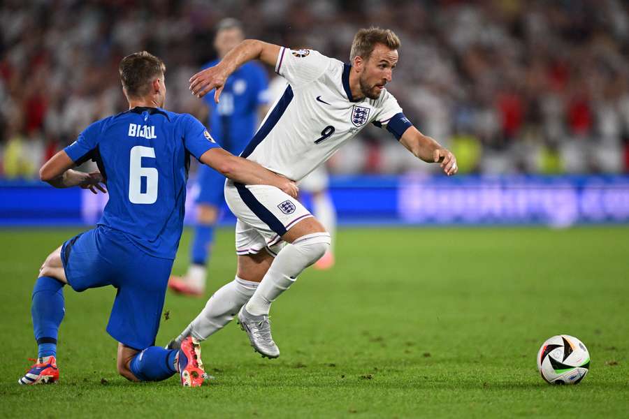 England's forward #09 Harry Kane is tackled by Slovenia's defender #06 Jaka Bijol 