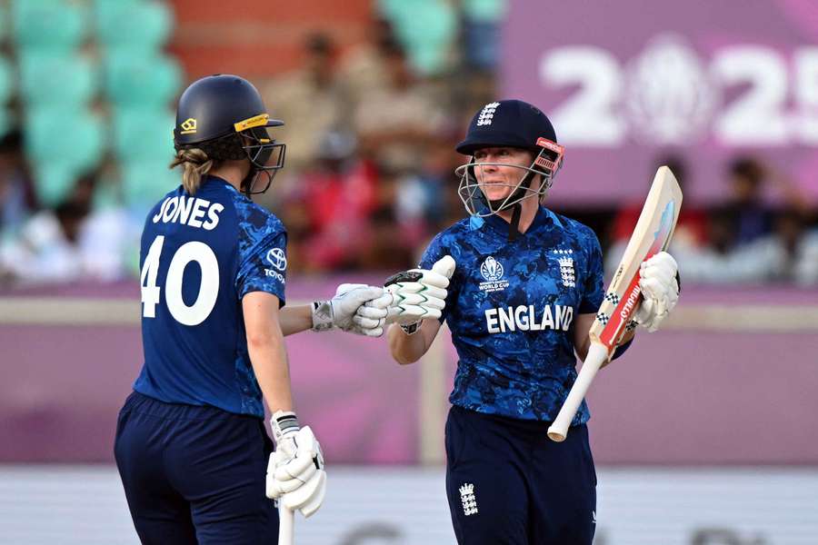 England's Amy Jones (L) touches gloves with teammate Heather Knight England's Amy Jones (L) touches gloves with teammate Heather Knight