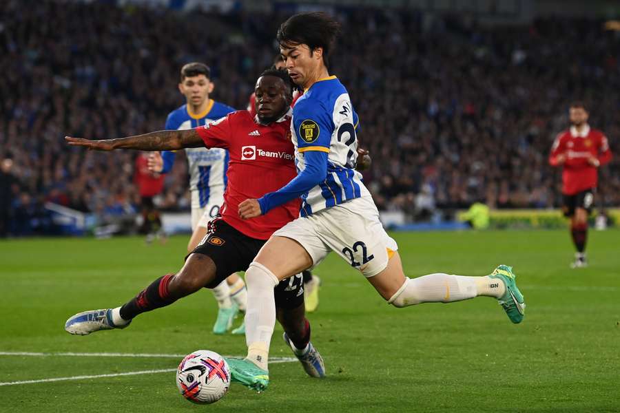 Aaron Wan-Bissaka slides in to tackle Kaoru Mitoma