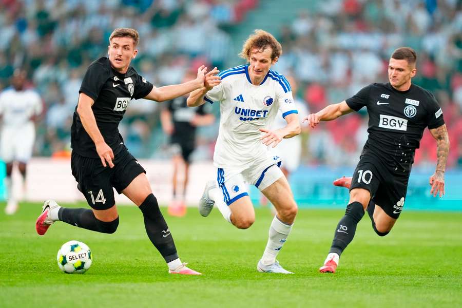Alex Kral of FC Copenhagen (C) in action against Lindon Emerllahu (L) and Vladyslav Veleten (R) of Polissya Zhytomy