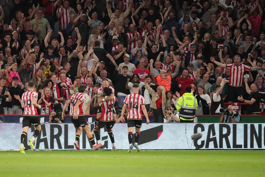 Sheffield United players celebrate in front of their fans