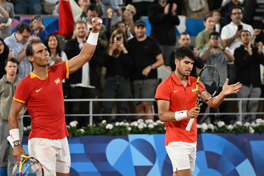 Spain's Rafael Nadal (L) and Spain's Carlos Alcaraz (R) celebrate after beating Argentina's Maximo Gonzalez and Argentina's Andres Molteni