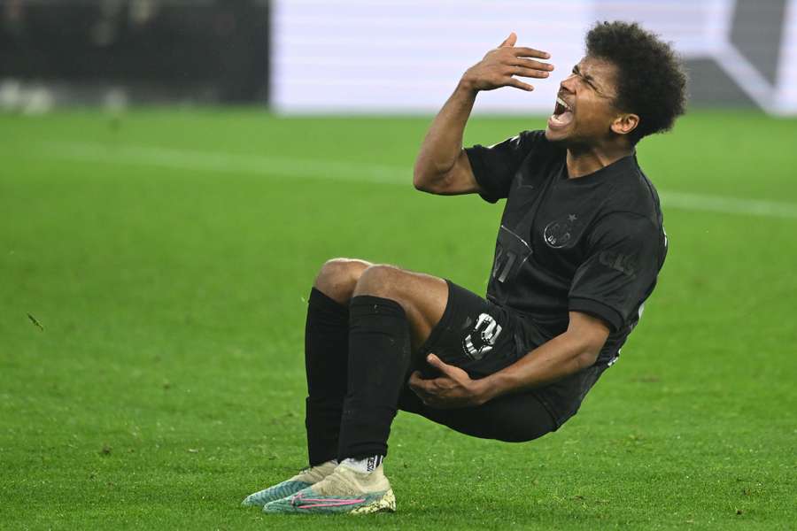 Dortmund's German forward Karim Adeyemi pulls up with an injury having played the ball setting up the second goal of the game