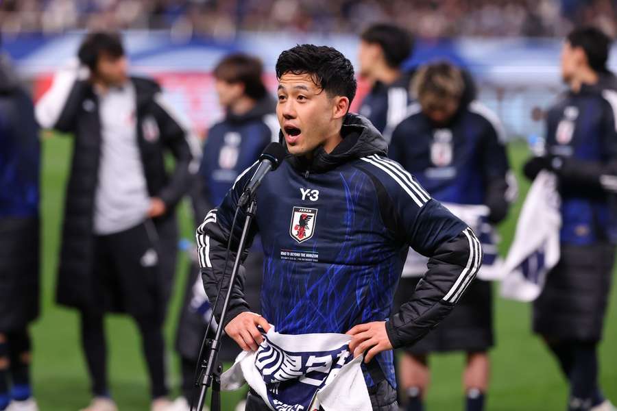 Wataru Endo speaks to supporters after Japan became the first team to qualify for the 2026 World Cup
