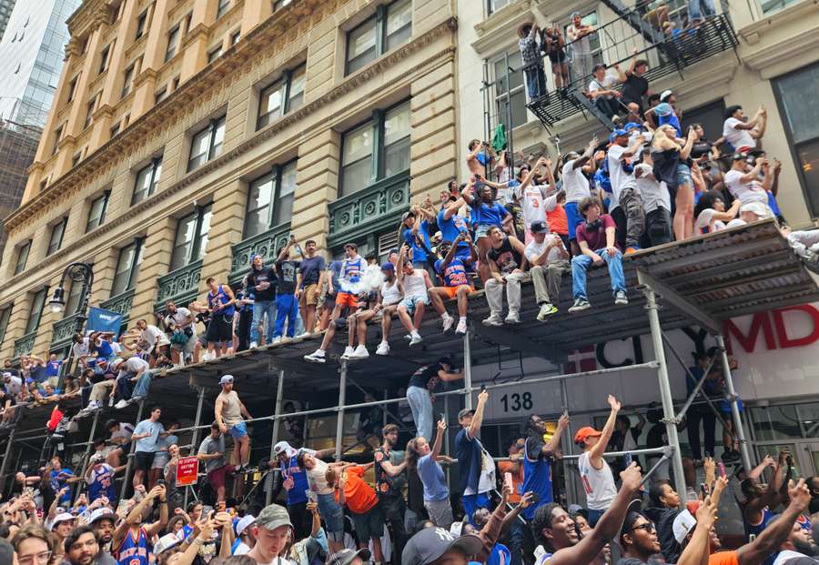 Dozens of fans climbed scaffolding around Manhatten to watch the parade Dozens of fans climbed scaffolding around Manhatten to watch the parade