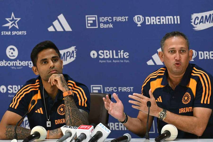 Indian cricket captain Suryakumar Yadav (L) and Ajit Agarkar, chairman of Board of Control for Cricket in India (BCCI), at a press conference