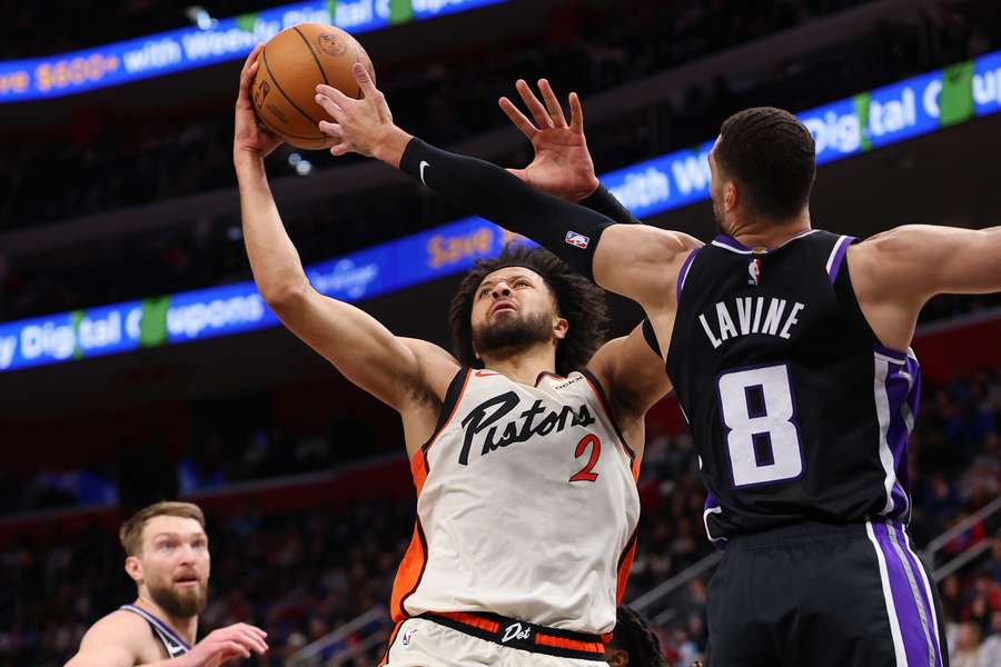 Cade Cunningham of the Detroit Pistons tries to get a shot off around Zach LaVine of the Sacramento Kings