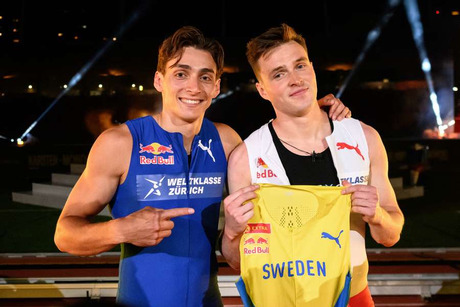 Mondo Duplantis (L) presents a Sweden jersey to be worn by Norwegian hurdler and sprinter Karsten Warholm after their race