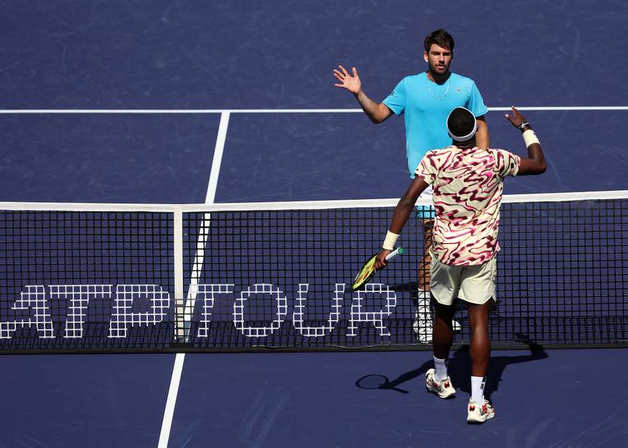 Frances Tiafoe of USA is congratulated by Cameron Norrie of Great Britain