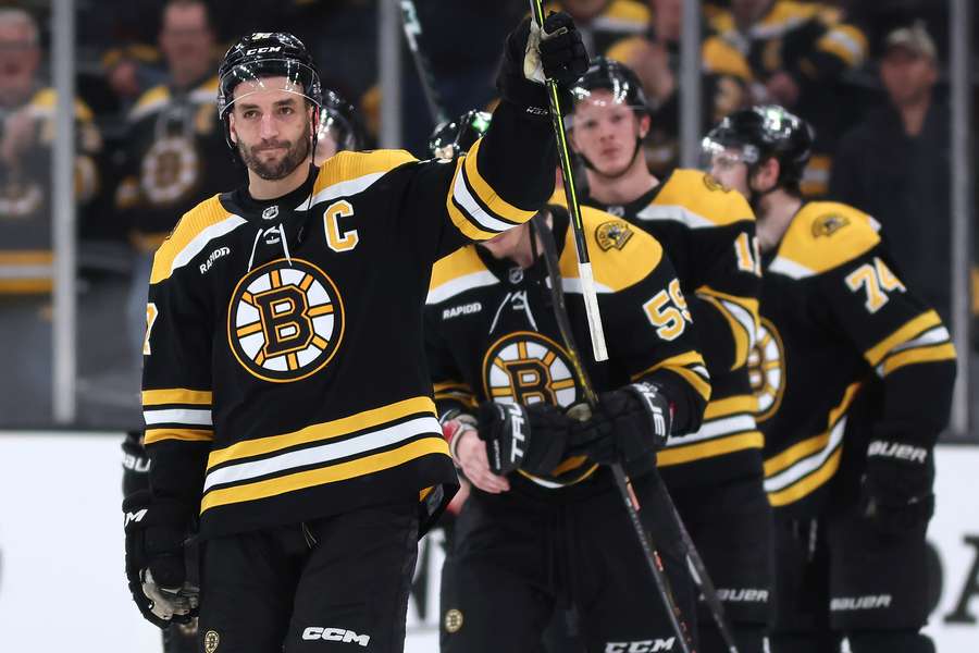 Patrice Bergeron of the Boston Bruins waves to fans