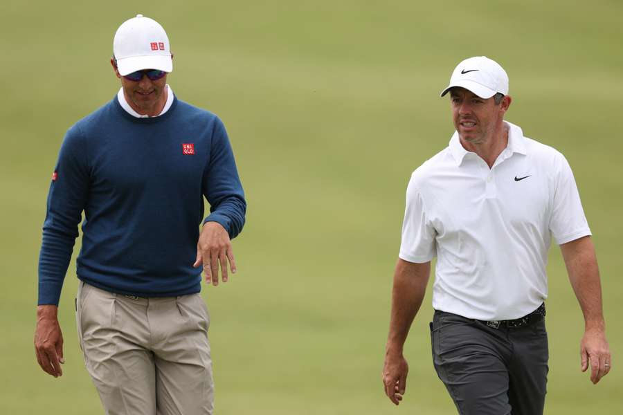 Adam Scott (L) and Rory McIlroy (R) walk the ninth hole of the Royal Melbourne Golf Club. Adam Scott (L) and Rory McIlroy (R) walk the ninth hole of the Royal Melbourne Golf Club.