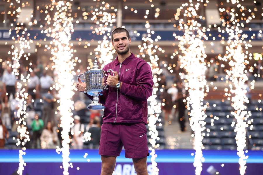 Carlos Alcaraz poses with the US Open trophy after winning the final.