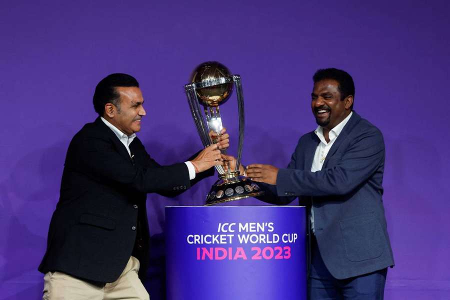 Virender Sehwag and Muttiah Muralitharan pose with the trophy