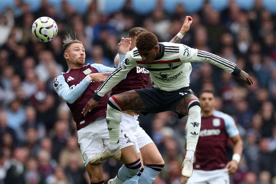 Matty Cash and Marcus Rashford jump for the ball during their match at Villa Park on Sunday