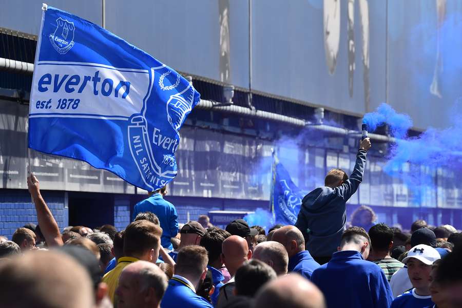 Everton supporters light blue flares before the start of the English Premier League football match between Everton and Bournemouth