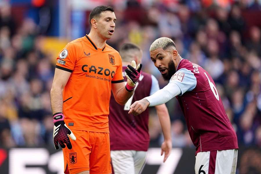 Aston Villa's Emiliano Martinez (L) and Douglas Luis (R)