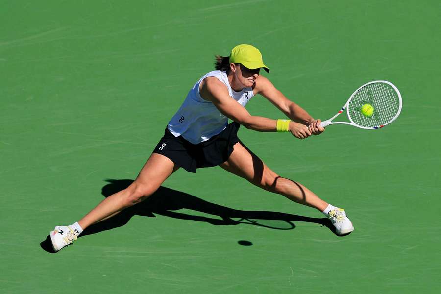 Iga Swiatek plays a backhand in her match against Dayana Yastremska