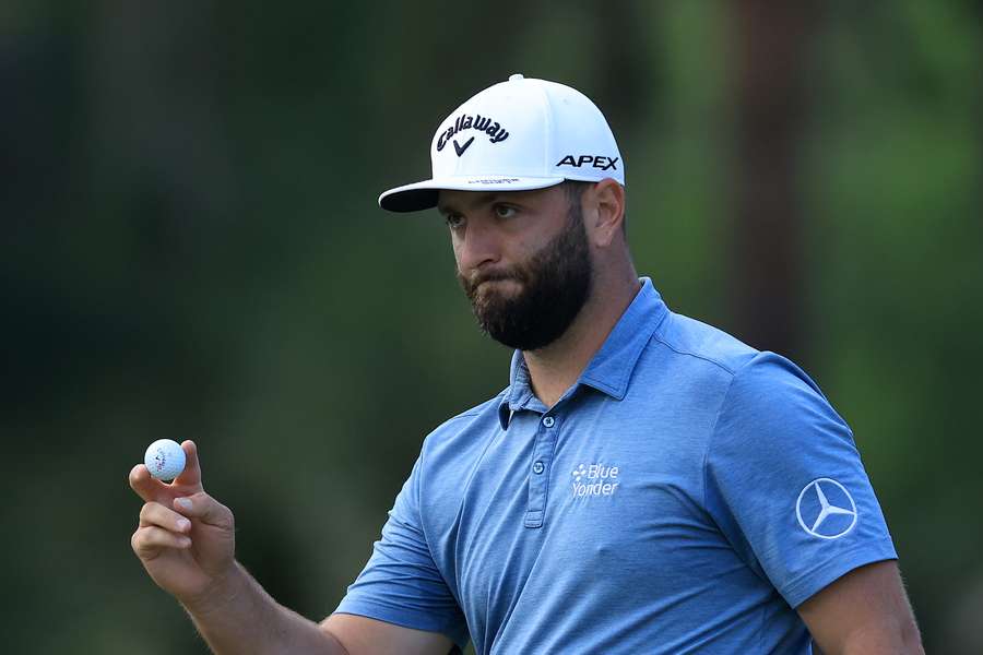 Jon Rahm of Spain waves after making birdie on the 13th hole