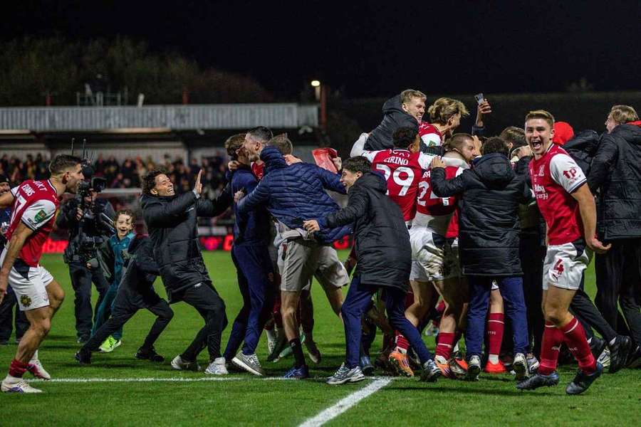 Fleetwood Town celebrate winning the penalty shootout against Arsenal with their fans Fleetwood Town celebrate winning the penalty shootout against Arsenal with their fans