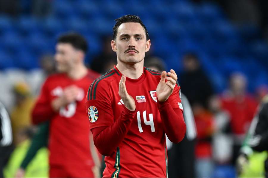 Connor Roberts claps the fans at full-time of their Euro 2024 qualifying play-off semi-final win over Finland