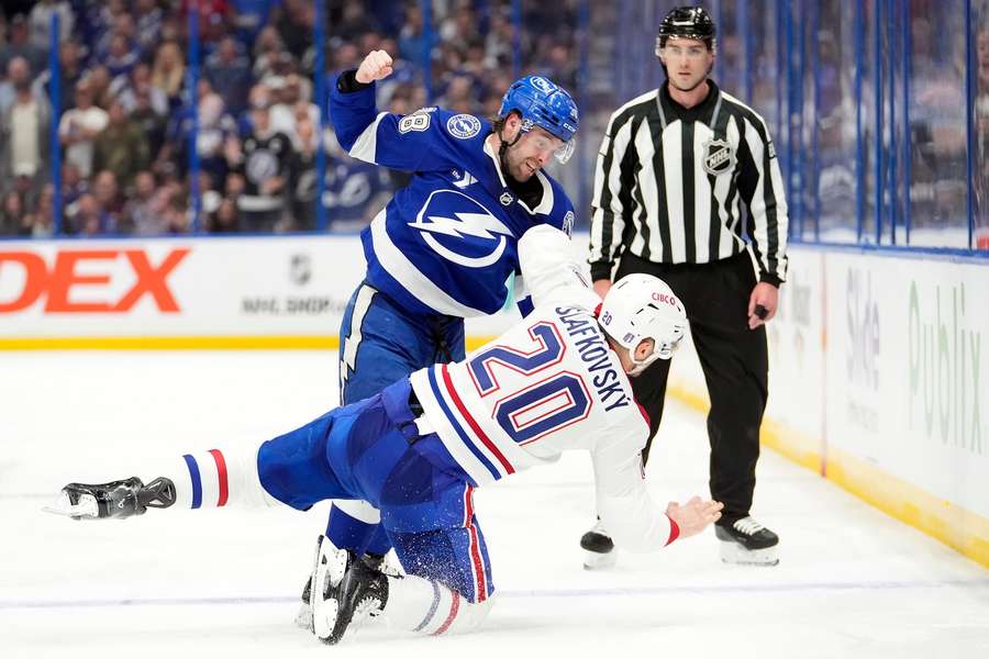 Lightning's Brandon Hagel (38) knocks down Montréal Canadiens Juraj Slafkovský (20) in Game 2