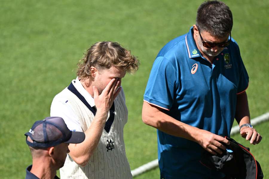 Will Pucovski is helped from the field after being struck in the head during a Sheffield Shield match in Hobart.