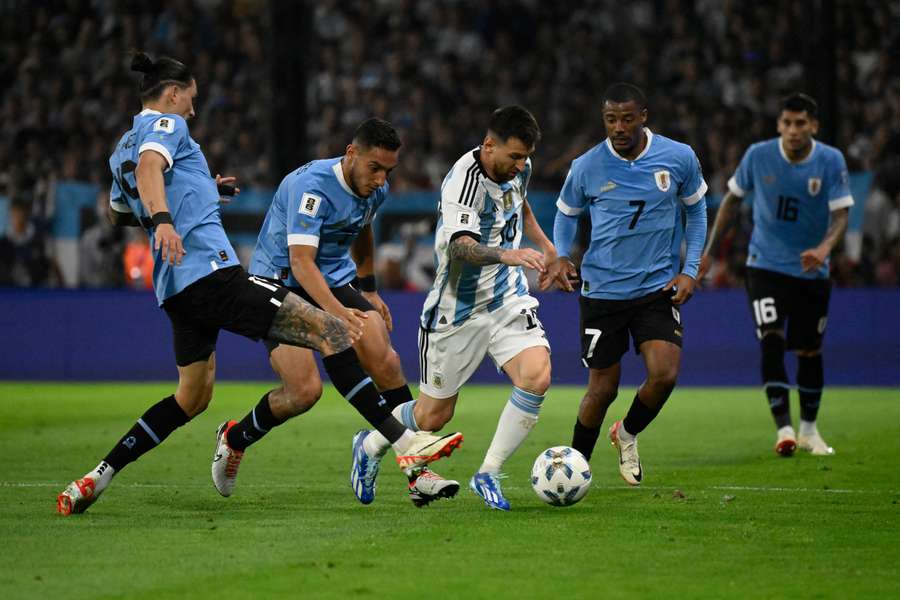 Argentina forward Lionel Messi (C) is challenged by Uruguay forward Darwin Nunez, defender Sebastian Caceres and midfielder Nicolas de la Cruz (2-R)