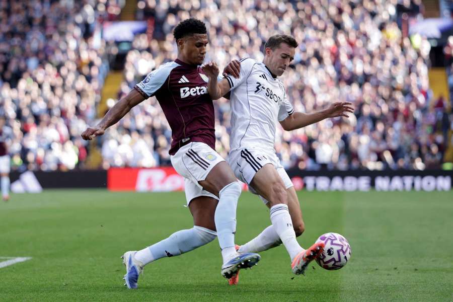 Watkins (left) battles for the ball