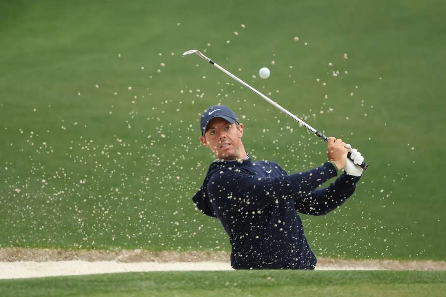 Rory McIlroy of Northern Ireland plays a shot from a bunker on the 16th hole during a Masters practice round