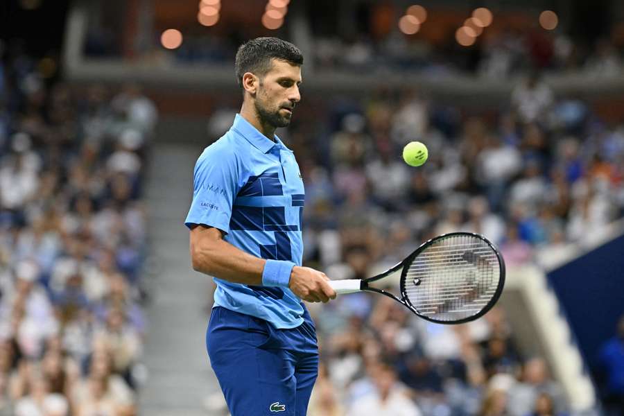 Novak Djokovic controls the ball as he plays against Alexei Popyrin