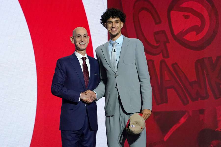 NBA commissioner Adam Silver poses with first overall pick Zaccharie Risacher