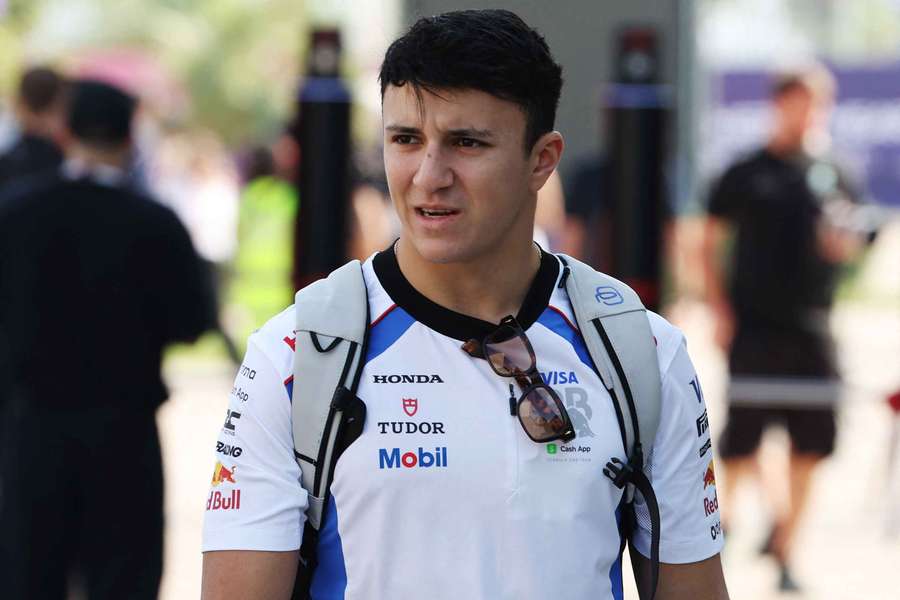 Isack Hadjar walks through the paddock