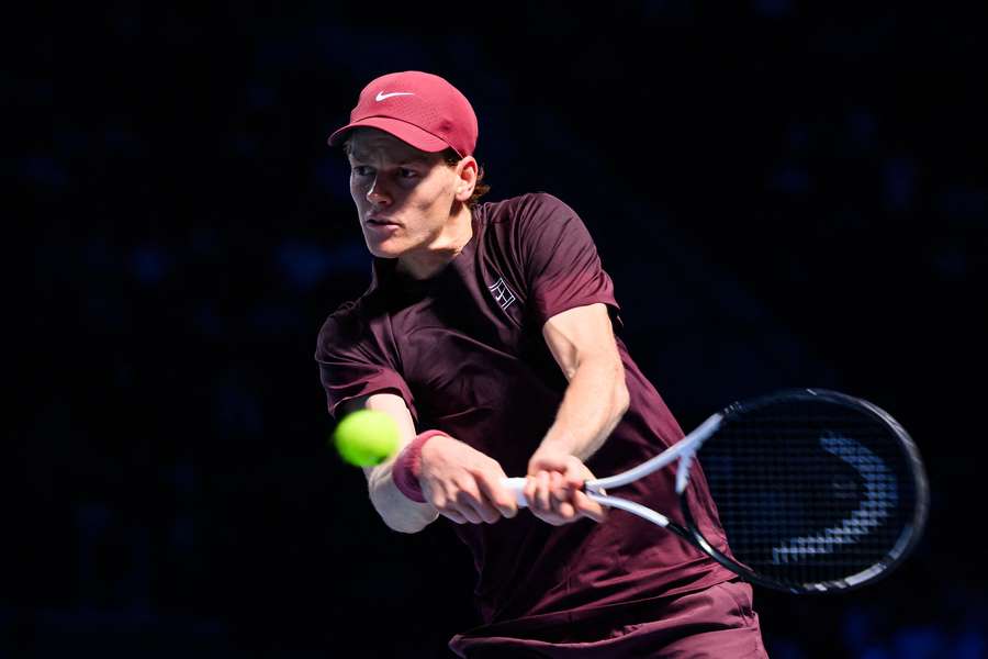 Jannik Sinner plays a backhand shot against Alex De Minaur in their semi-final clash