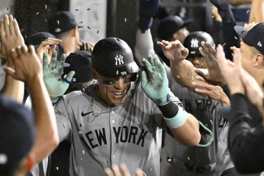 Aaron Judge celebrates in the dugout after hitting his 300th home run