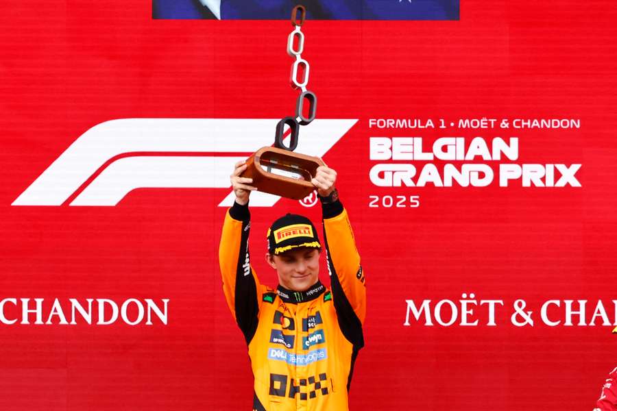 Oscar Piastri lifts the trophy after winning the Belgian Grand Prix